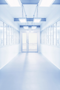 Brightly lit, sterile, and modern laboratory hallway reflecting GMP and ISO-certified manufacturing standards and quality control processes